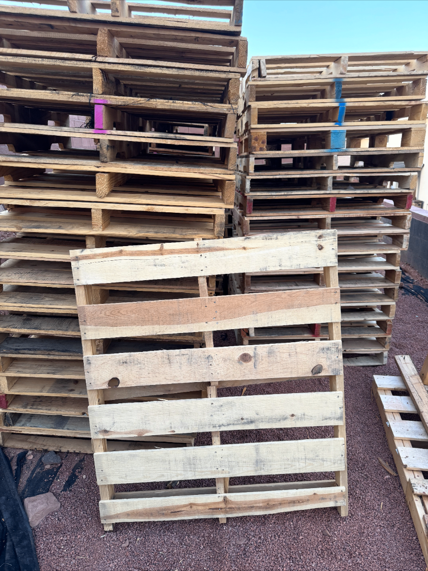 Reclaimed pallet boards and stacked pallets ready for pickup